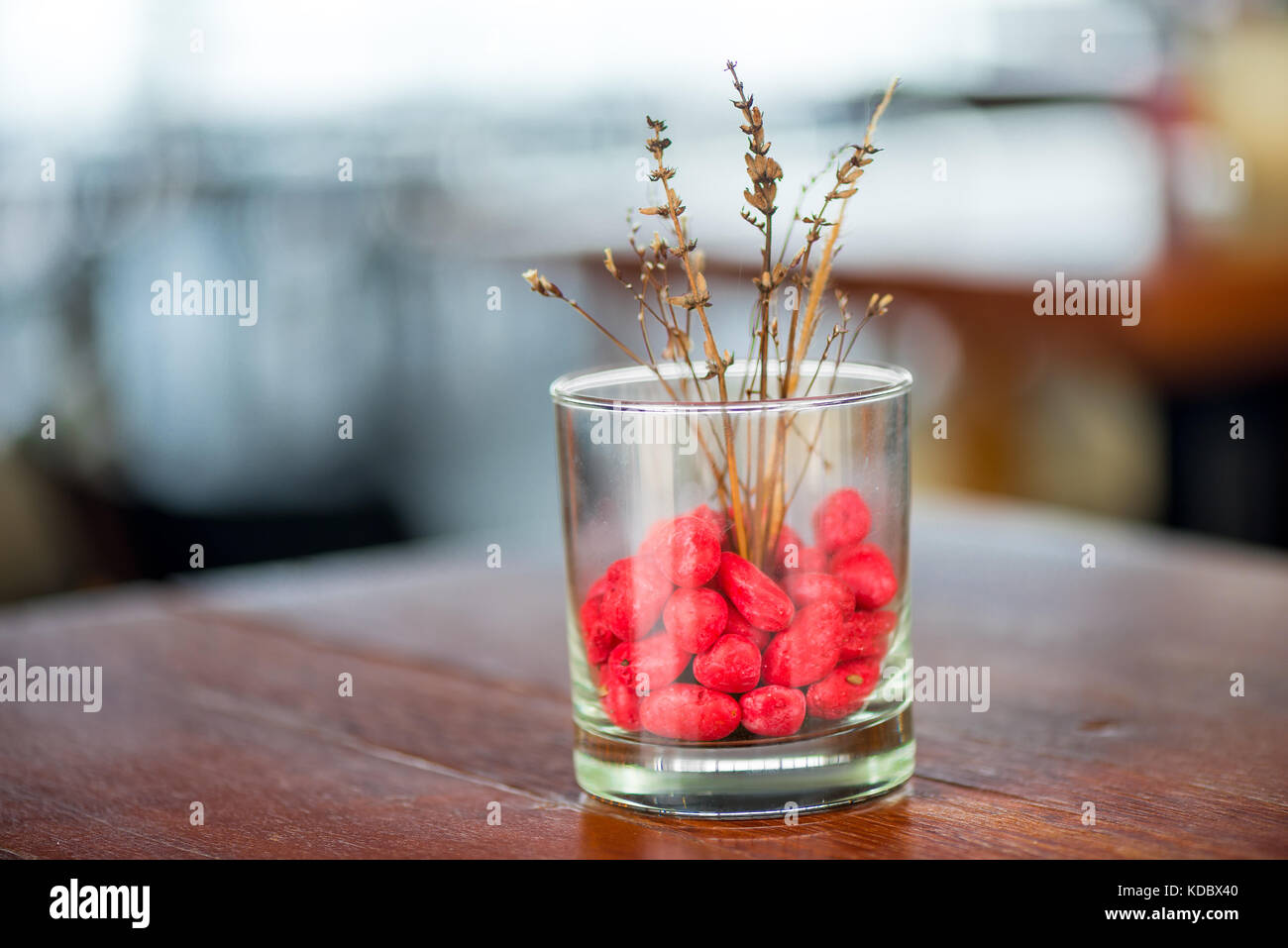 Decorative Glass Vase With Colored Stones And Dry Flowers Close Up