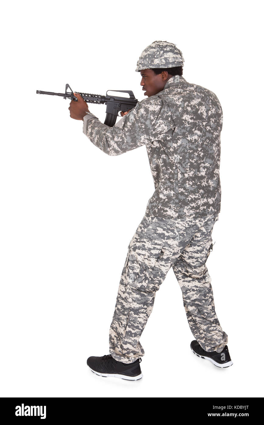 Portrait Of A Male African Soldier Aiming With Gun Isolated Over White Background Stock Photo