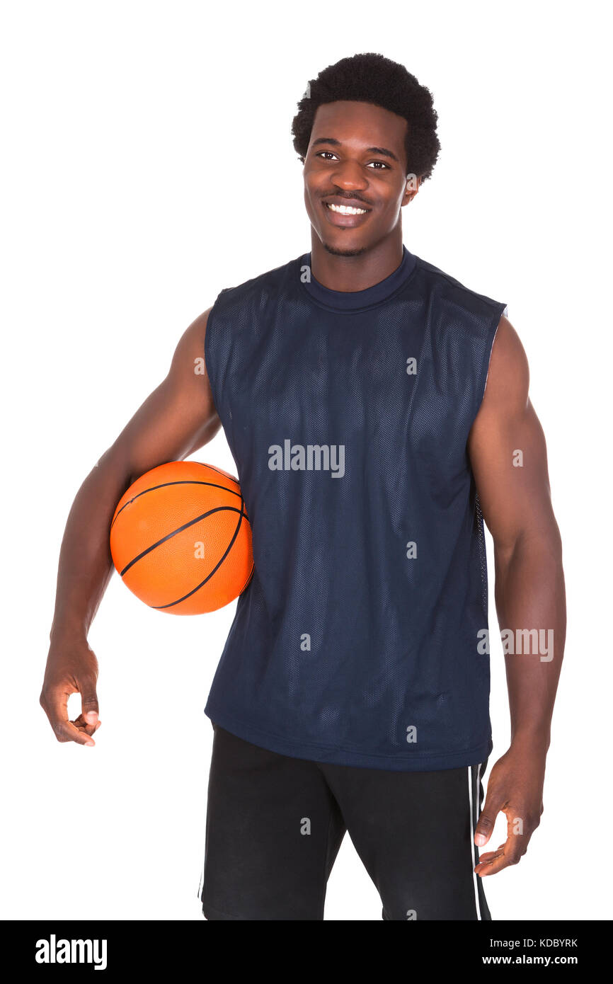 Man Posing in Basketball Tank Top on White Fabric · Free Stock Photo