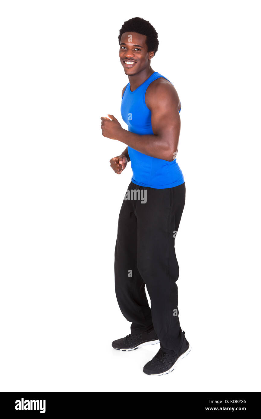 Portrait Of A African Young Man Jogging Over White Background Stock Photo