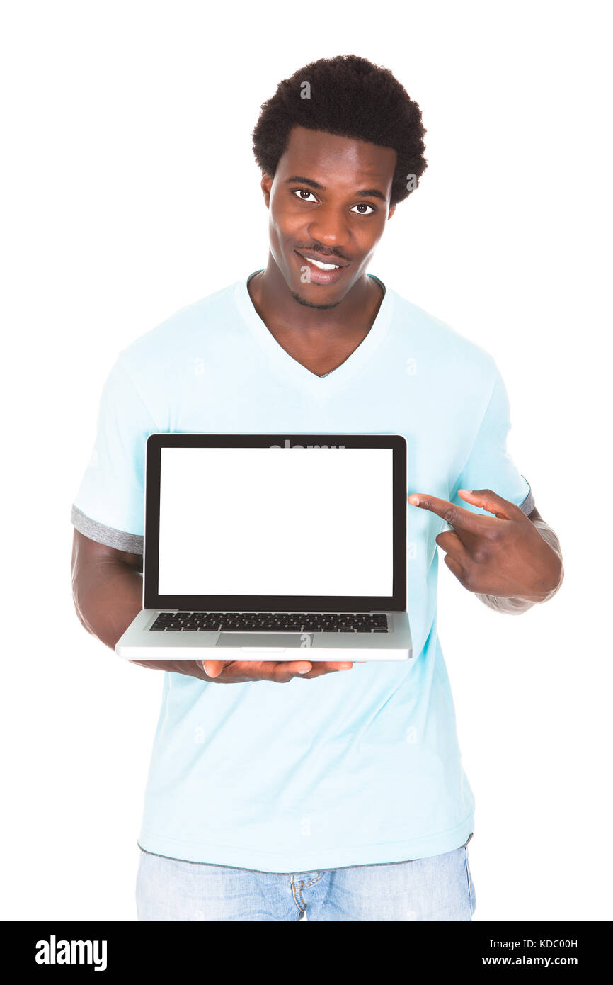 Happy Young African Man Using Laptop Isolated Over White Background Stock Photo