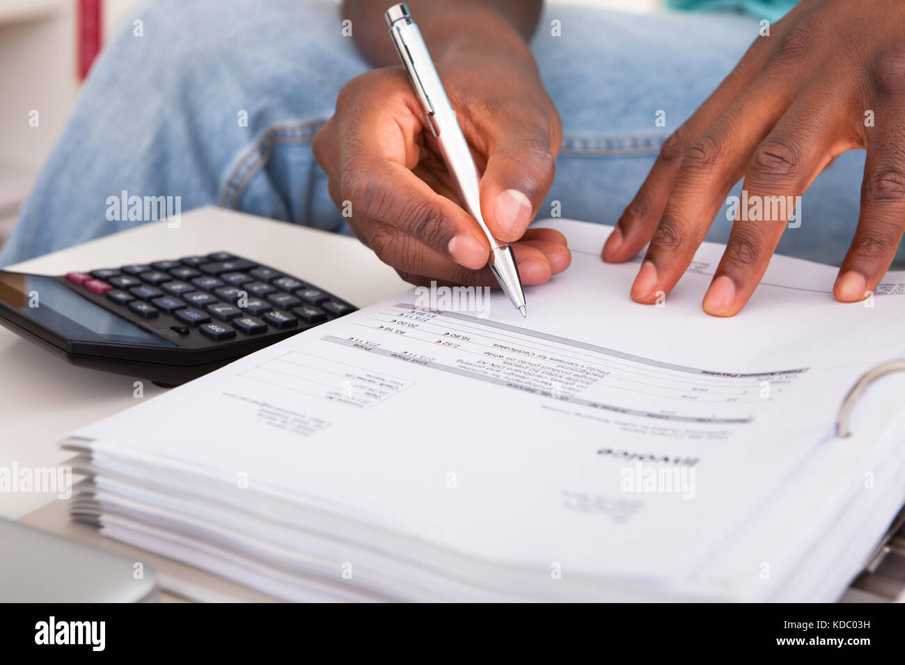 African Young Man Calculating His Finance Expenses At Home Stock Photo