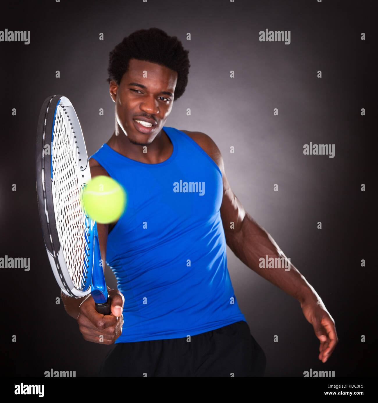 Young African Man Playing Tennis With Tennis Racket Stock Photo