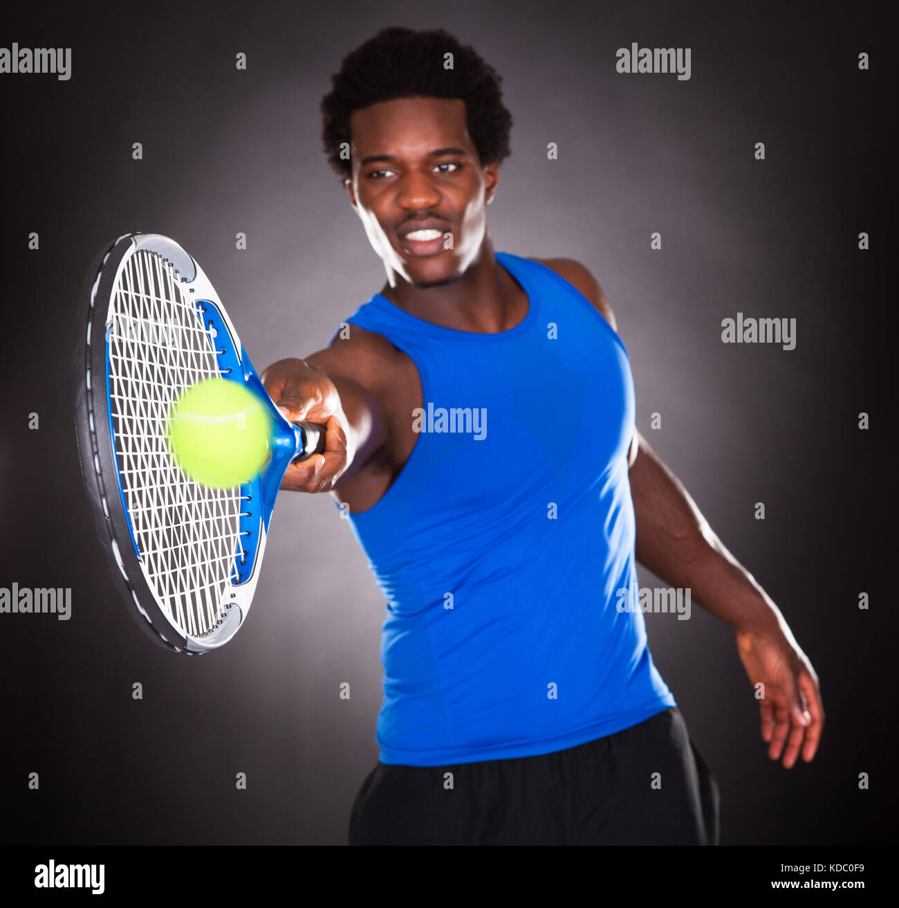 Young African Man Playing Tennis With Tennis Racket Stock Photo