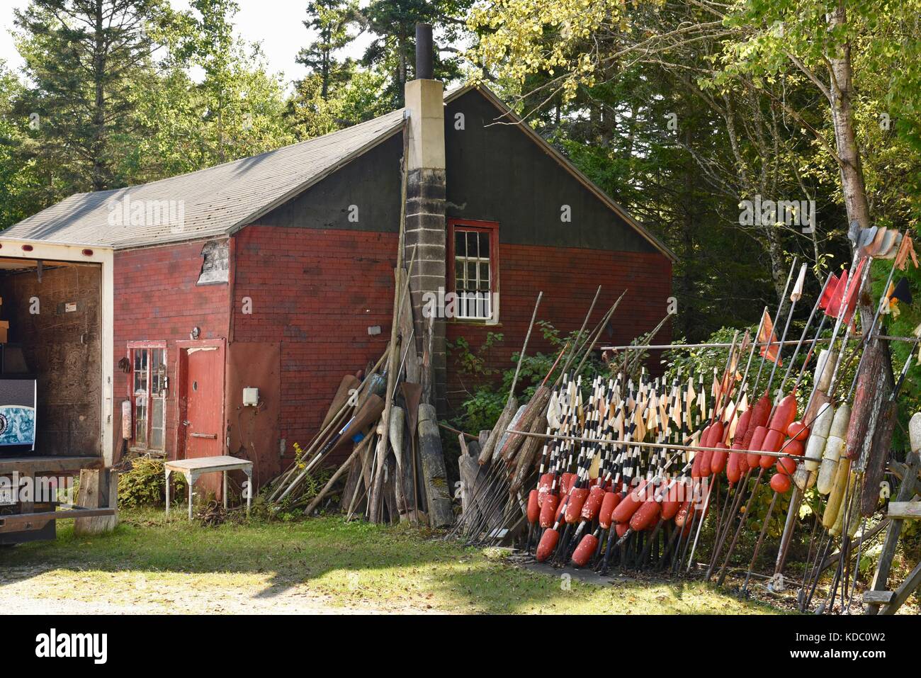 Buoys and markers piled up alongside fishing shed for Baileys Harbor