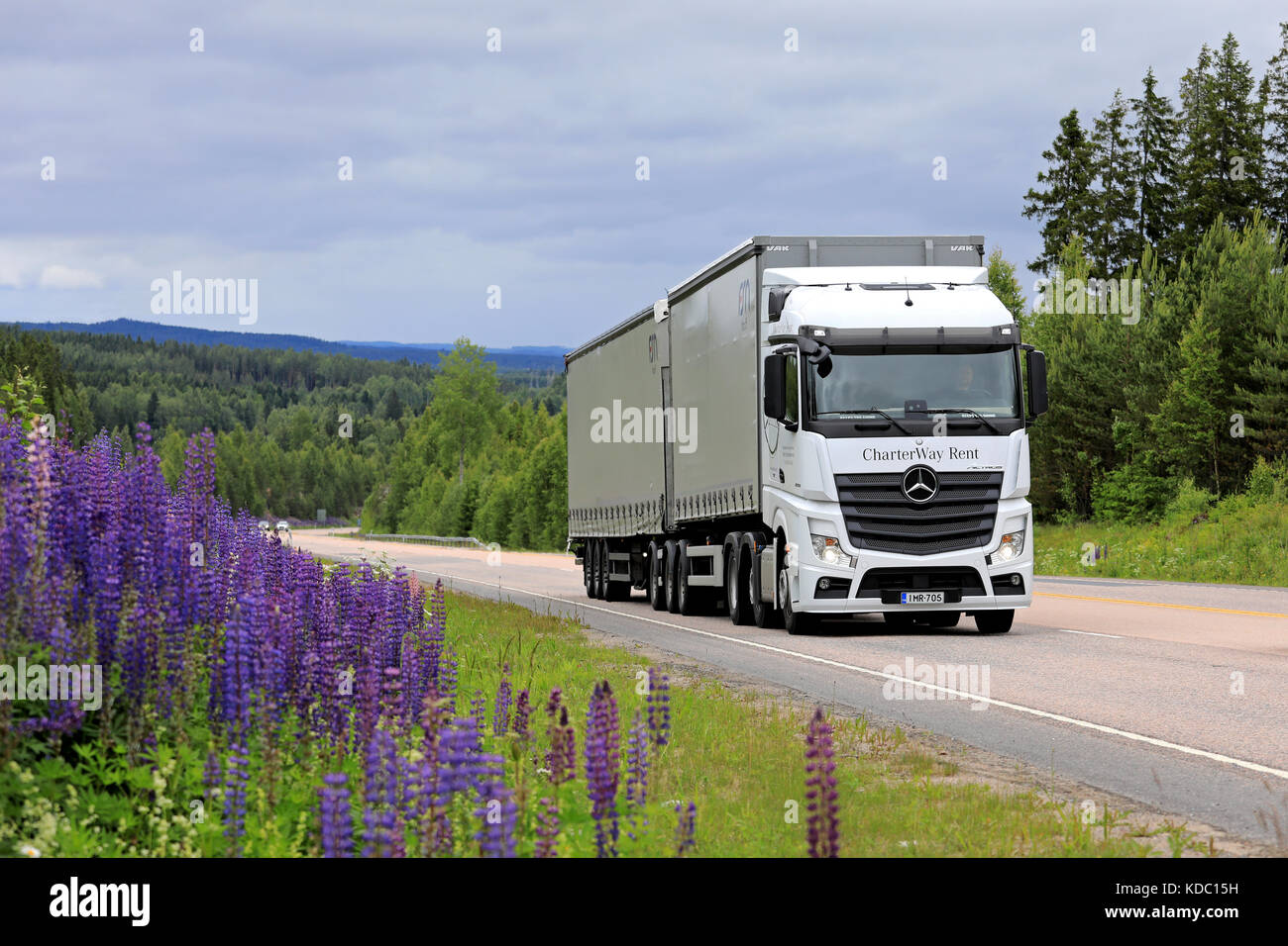 JAMSA, FINLAND - JULY 6, 2017: White Mercedes-Benz Actros 2551 cargo truck transports goods along scenic highway in Central Finland at summer. Stock Photo
