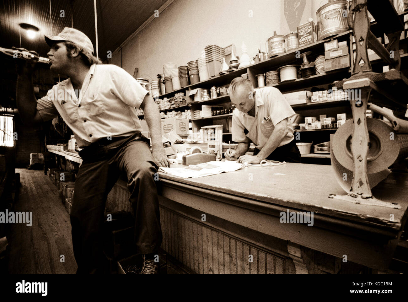 Ernest Turner tallies up a customer's account in his hardware store in