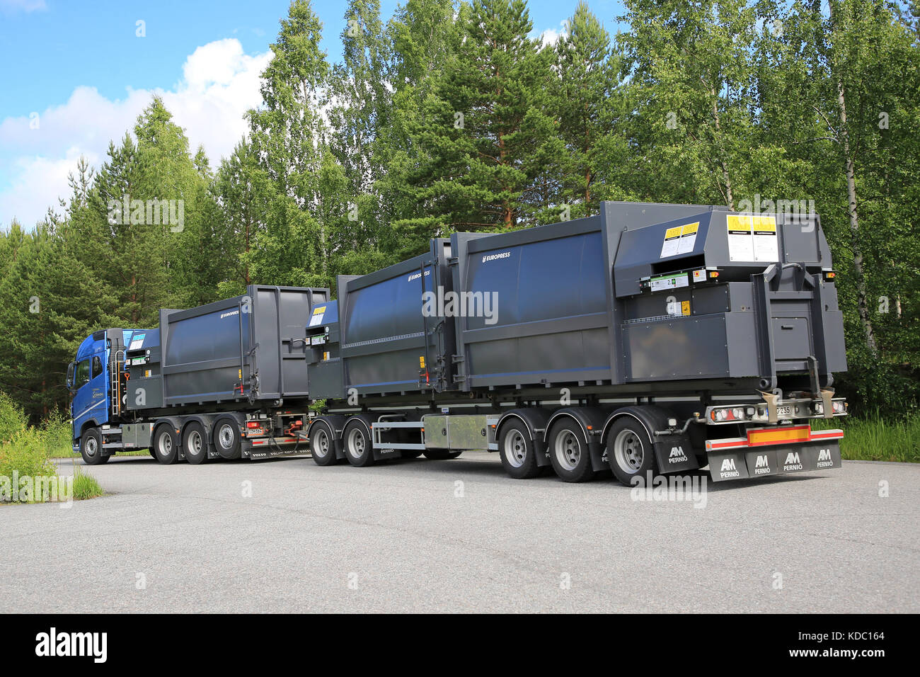 LEMPAALA, FINLAND - JULY 6, 2017: Blue Volvo FH transports Europress waste compactors, rear view. Stock Photo