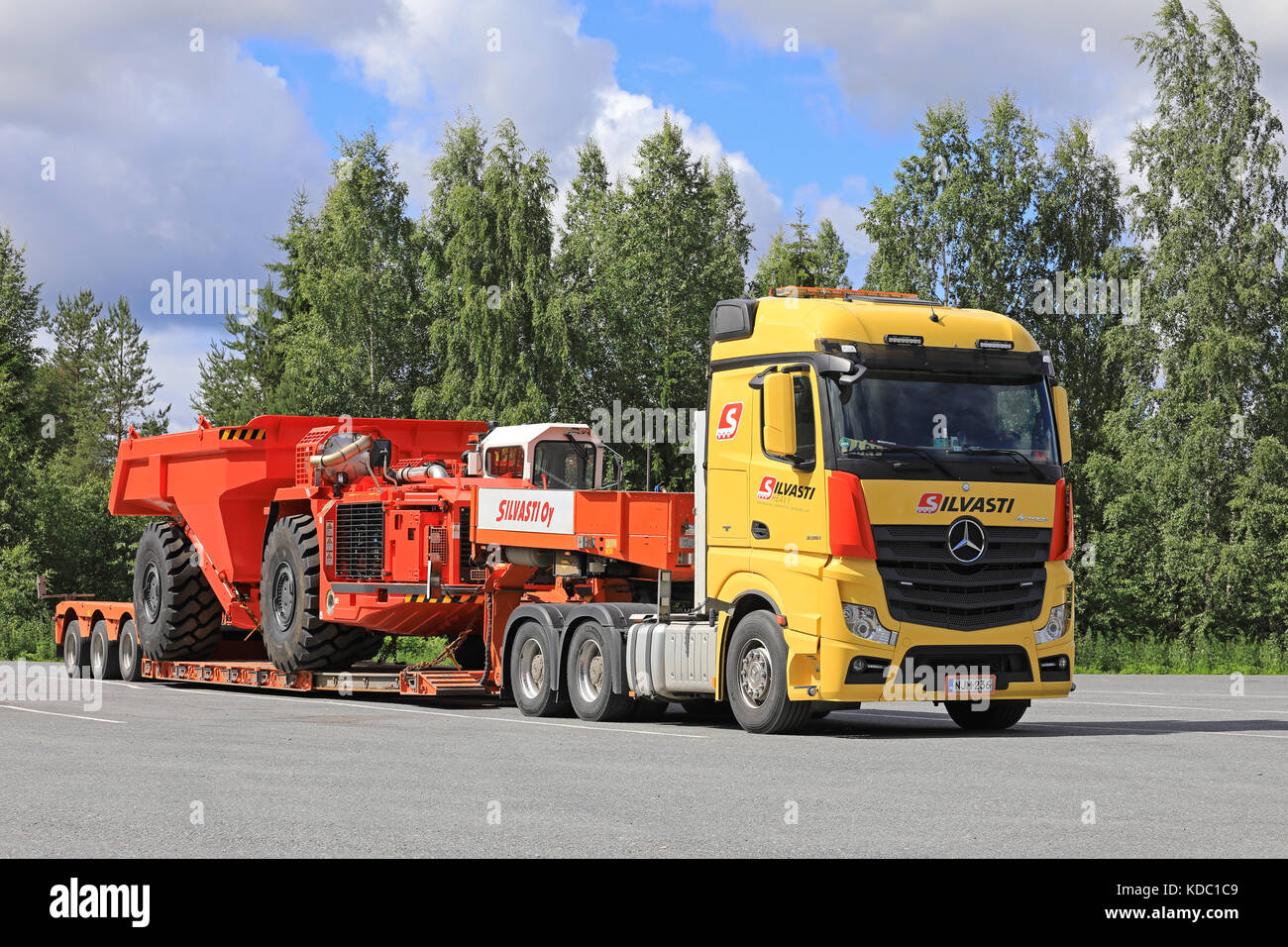 LEMPAALA, FINLAND - JULY 6, 2017: Transport of Sandvik TH550 Underground Truck by Silvasti Heavy Mercedes-Benz Actros 3351 on the asphalt yard of a tr Stock Photo