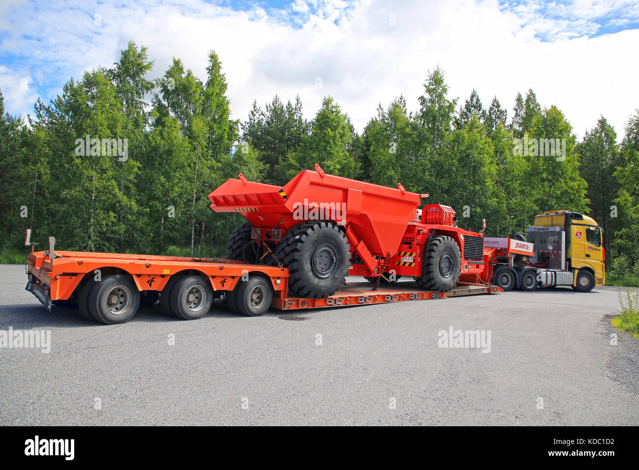 LEMPAALA, FINLAND - JULY 6, 2017: Mercedes-Benz Actros 3351 of Silvasti Heavy transports Sandvik Underground Truck on gooseneck trailer. The mining ve Stock Photo