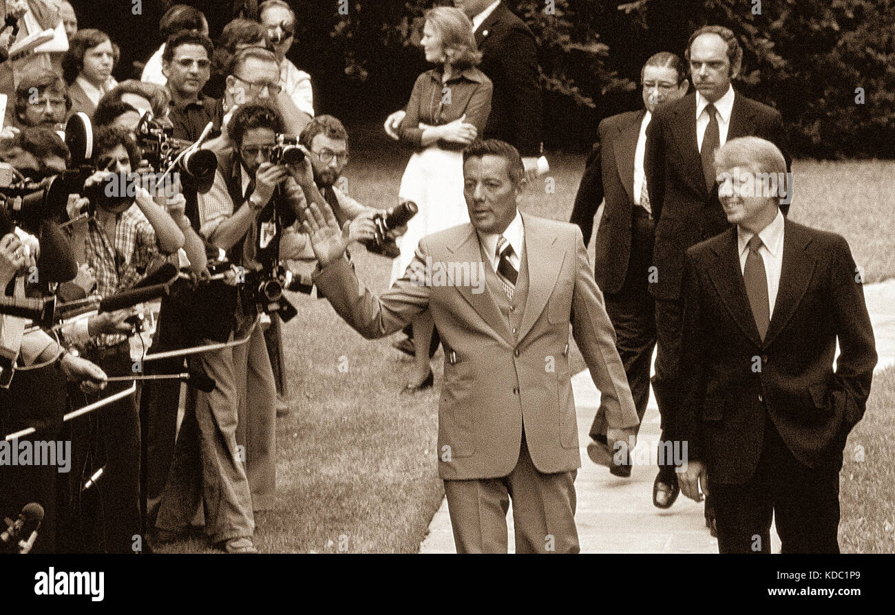 Carter and Panamaís Omar Torrijos walk past the press on the eve of the signing of the Panama Canal Treaty. The agreement gave Panama sovereignty over Stock Photo