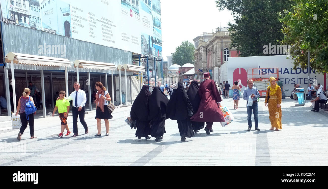 Istanbul, Turkey - August 23, 2017: Group of veiled muslim women walk with a man in Istanbul's Eminonu district. Stock Photo