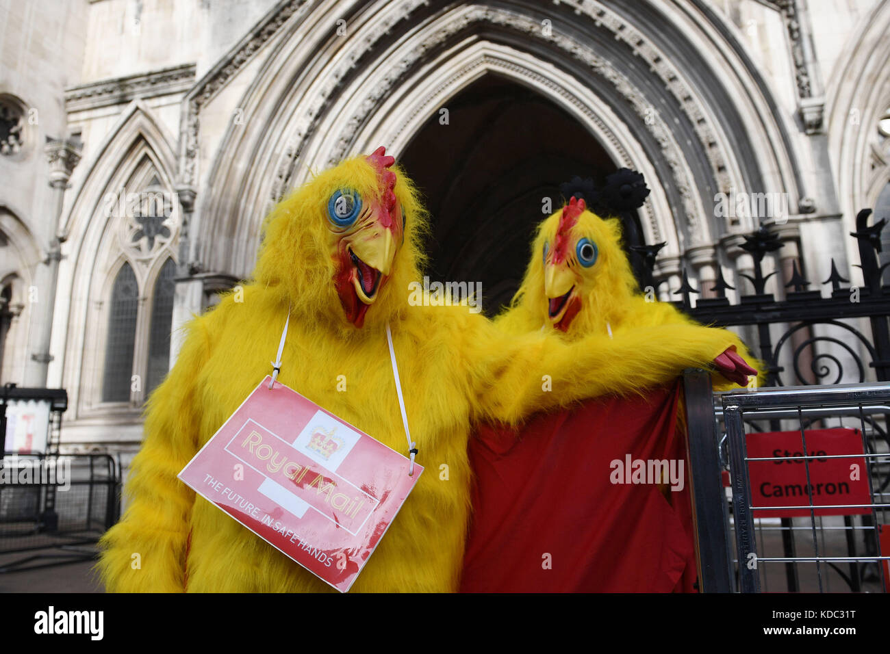 Postal workers protest outside the High Court ahead of a bid by the Royal Mail to seek an injunction stopping a planned strike. Stock Photo