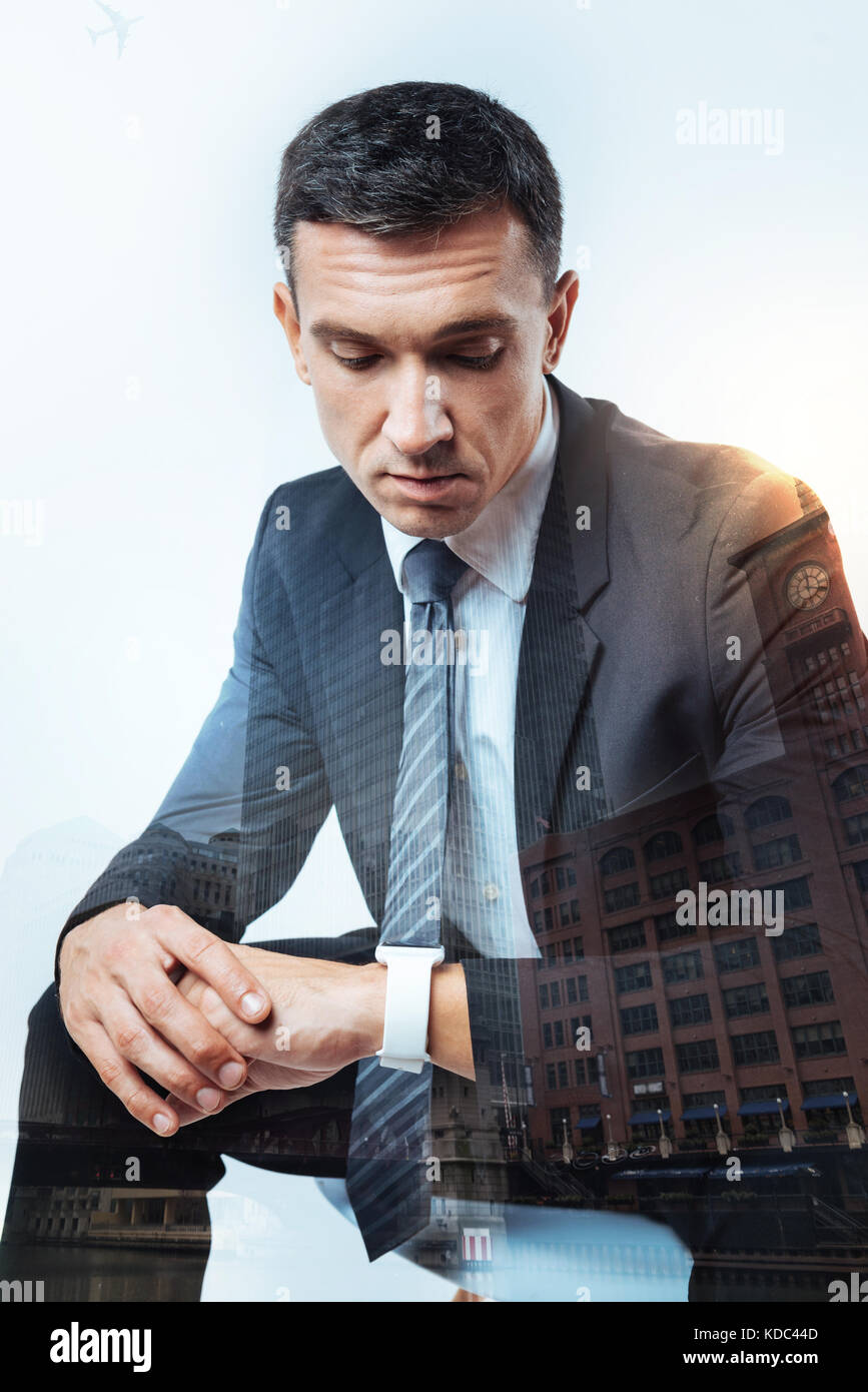 Serious man looking at his new smart watch Stock Photo
