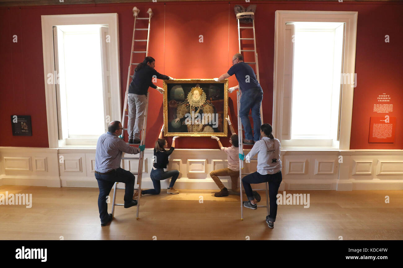 Art handlers reinstall the Armada Portrait of Elizabeth I in the Queen’s House, Royal Museums Greenwich, London, following conservation work. Stock Photo