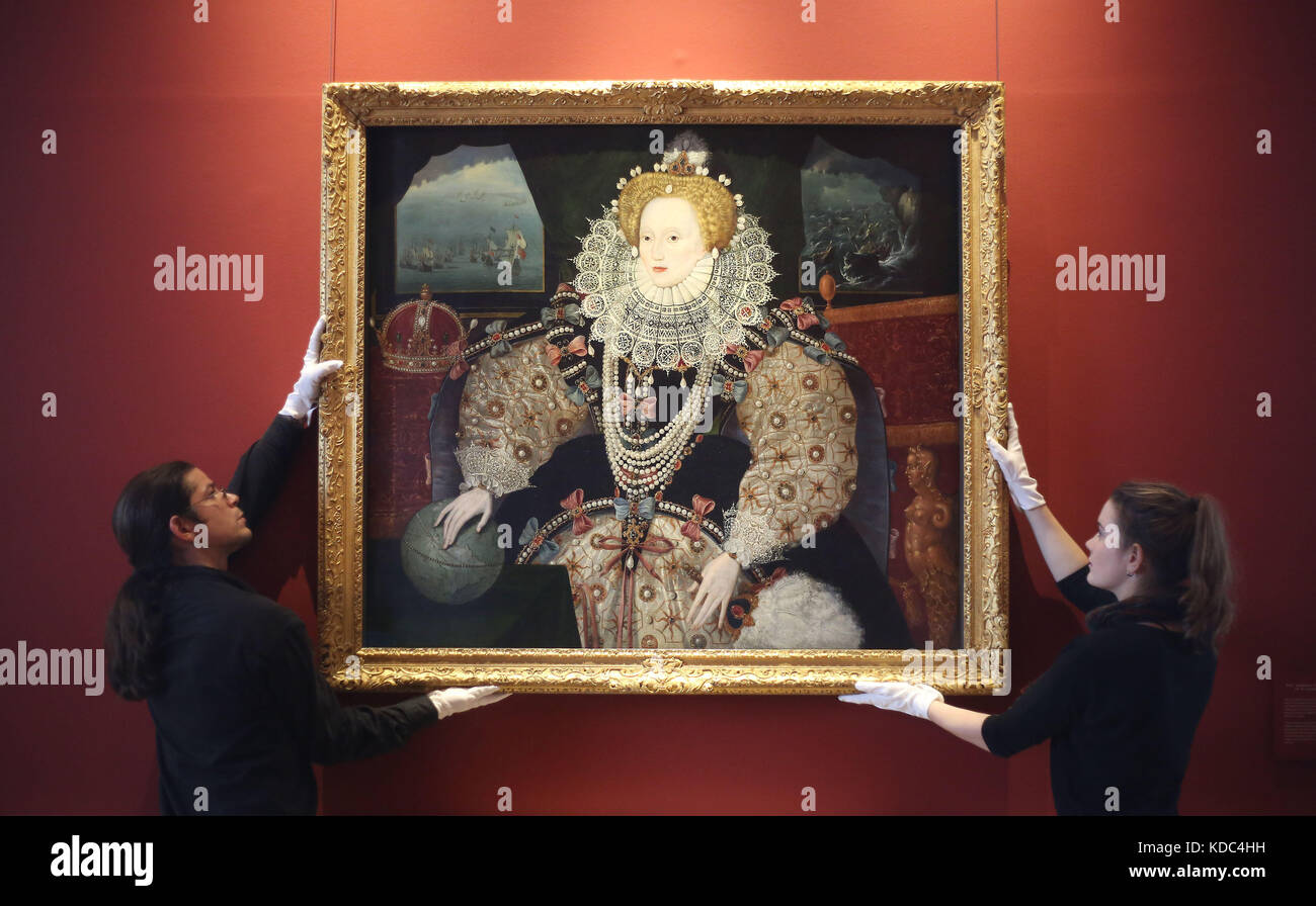 Art handlers reinstall the Armada Portrait of Elizabeth I in the Queen’s House, Royal Museums Greenwich, London, following conservation work. Stock Photo