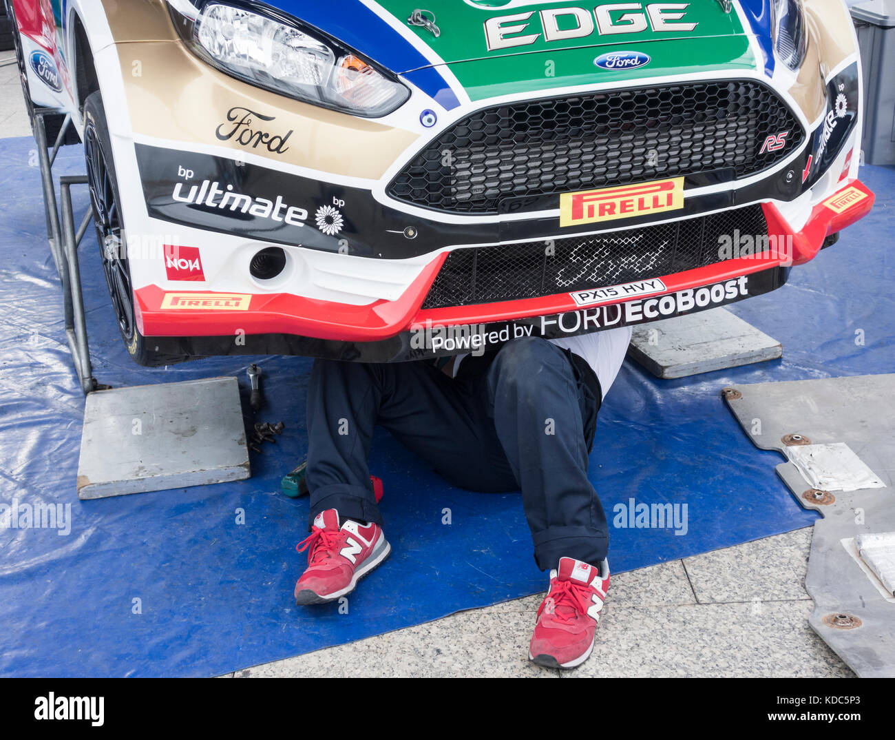 Rally mechanic under car at Gran Canaria rally. Stock Photo