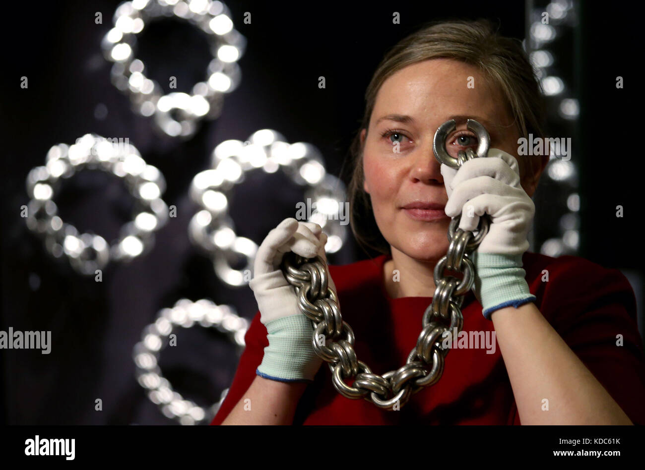 Research fellow Alice Blackwell takes a closer look at a Pictish neck chain during an exhibition to showcase the importance of silver in Scotland's history, at the National Museum of Scotland in Edinburgh. Stock Photo