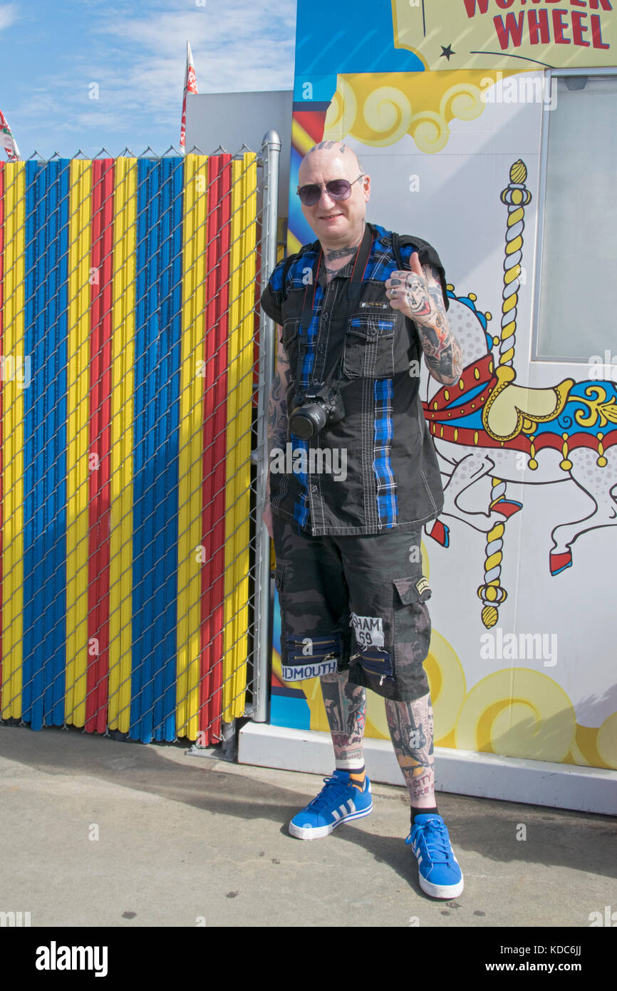 A British tourist from Newcastle covered in Tattoos visiting the Boardwalk in Coney Island Brooklyn, New York City. Stock Photo