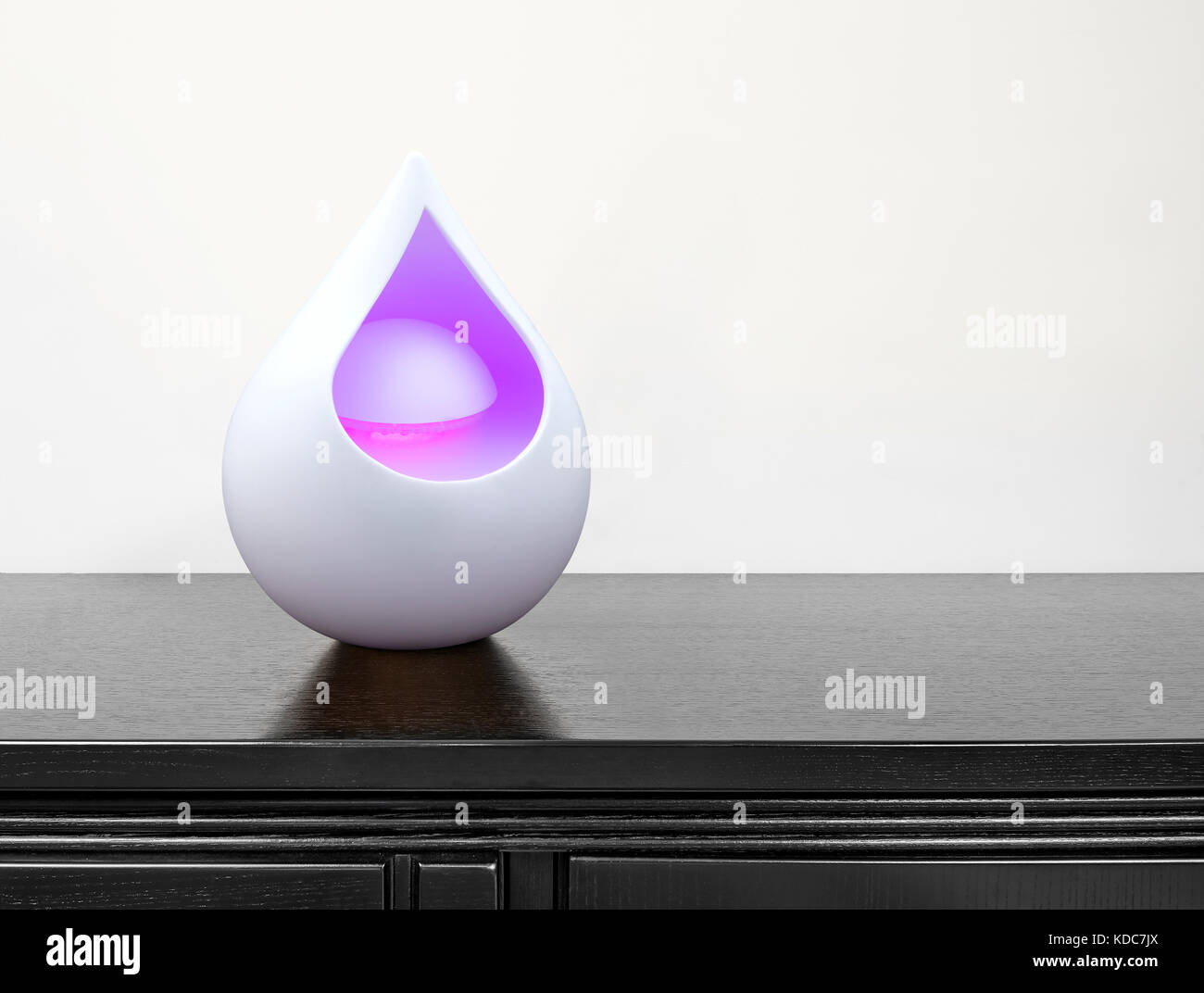 Colored Air Freshener In Glass Container On Black Desk Stock Photo