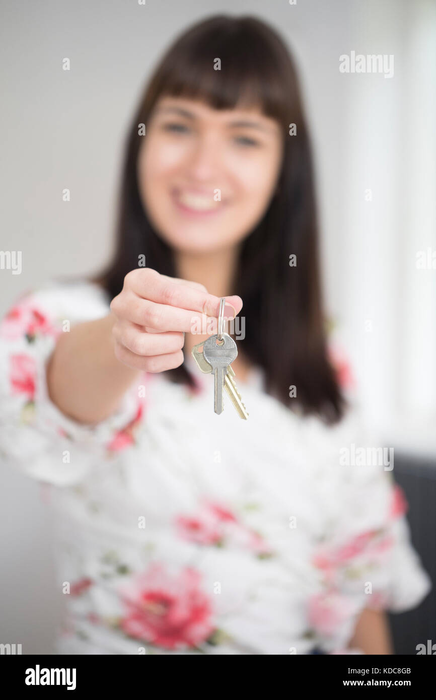 Woman Moving Into New Home Holding Bunch Of Keys Stock Photo