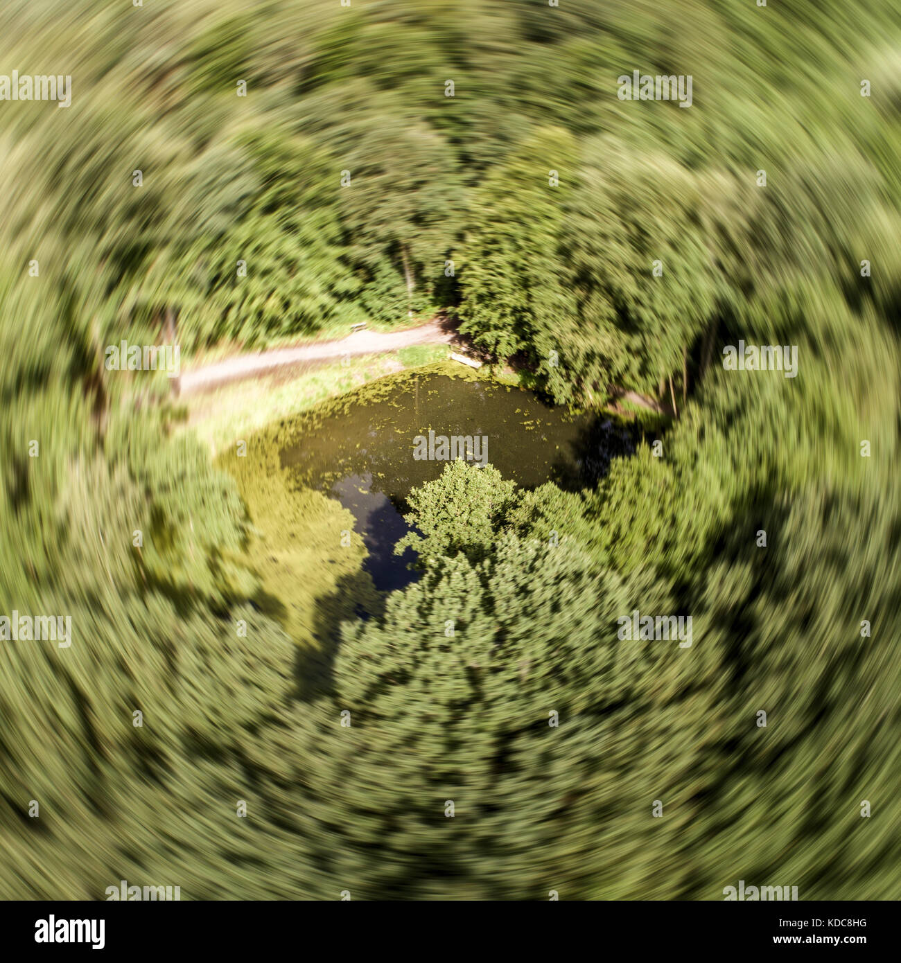 Abstract aerial photograph of a pond in the forest with circular blur, photographed with the drone Stock Photo