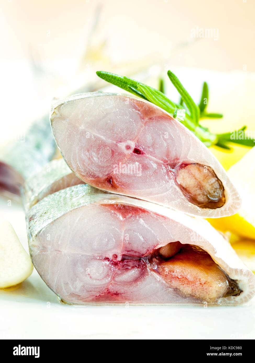 Fresh cutting Mackeral in olive oil with garlic and rosemary on the white plate . Selective focus shallow depth of field . Stock Photo