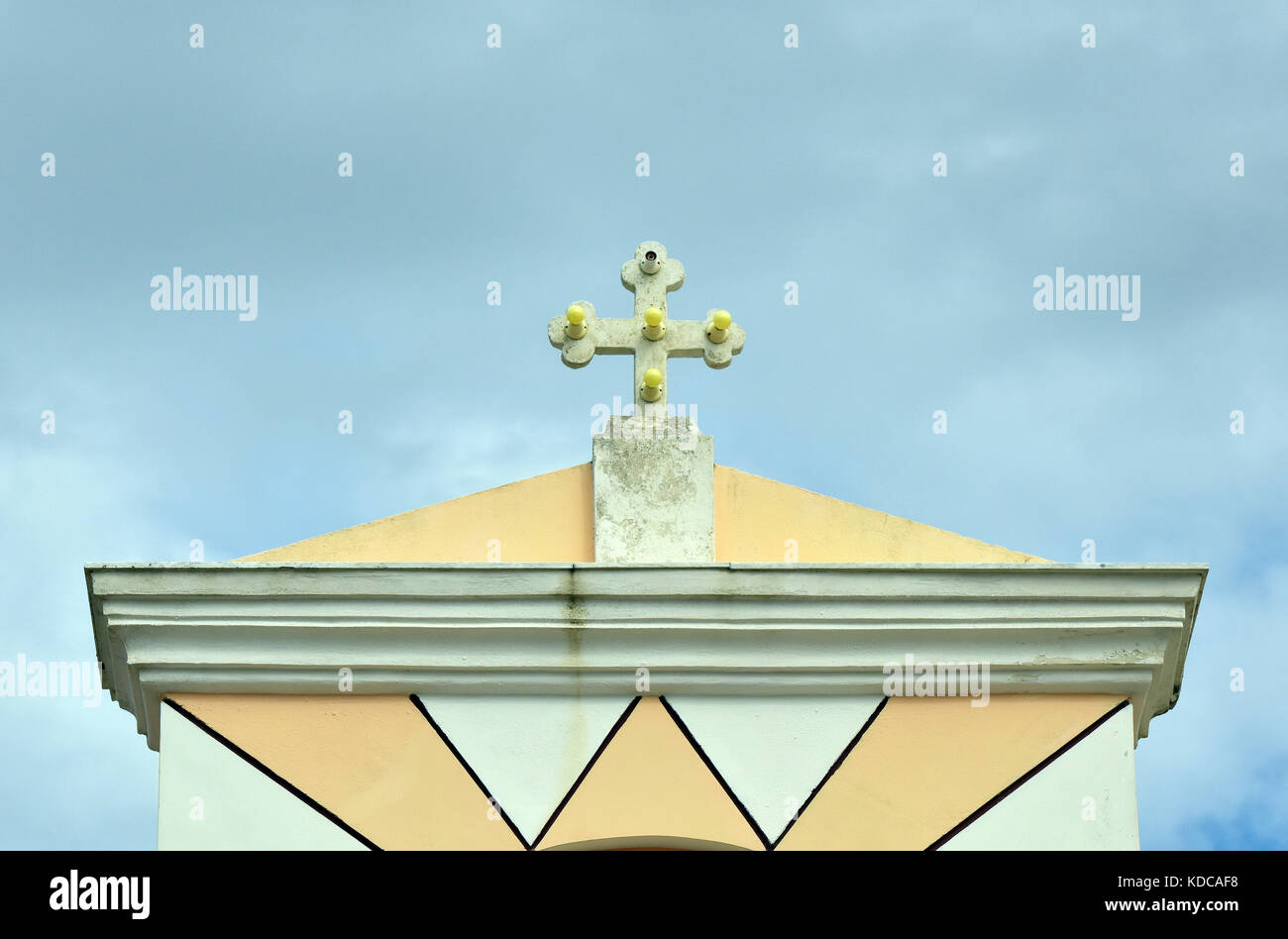 an illuminated cross on the top of a greek orthodox church in daylight ...