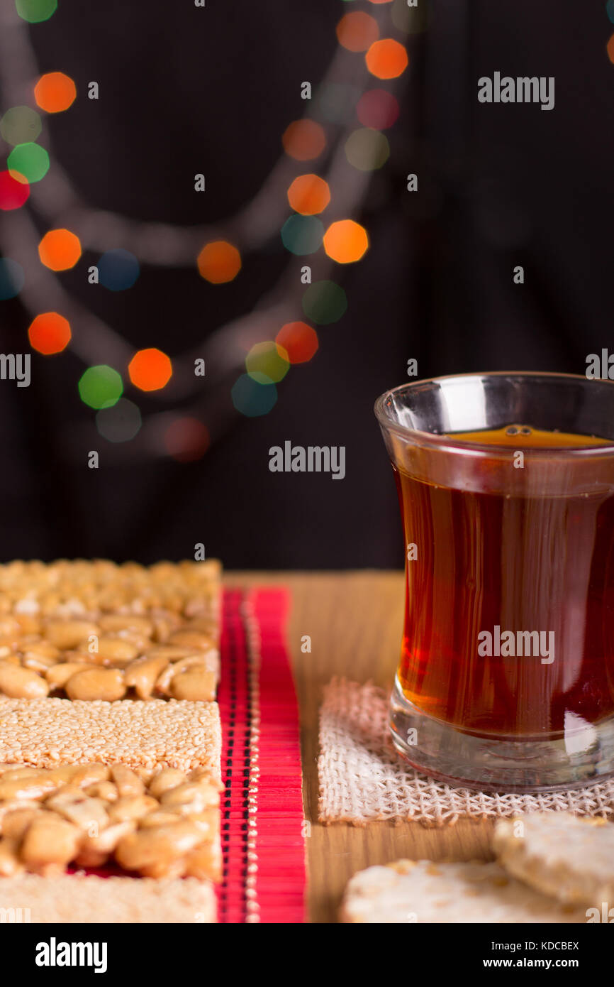 Collection of Beans Candies and Sweets Sweets ( Mawlid Halawa ) with Cup of tea - Egyptian Culture Dessert Eaten During Prophet Muhammad Birthday Stock Photo
