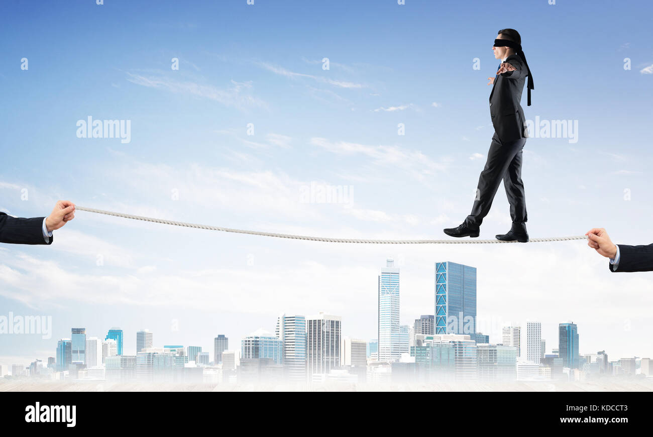 Business concept of risk support and assistance with man balancing on ...