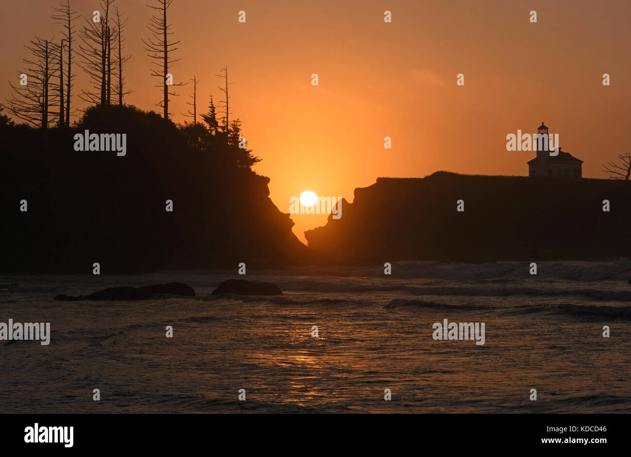 Sunset between the rocks on Lighthouse Beach near Coos Bay, Oregon Stock Photo