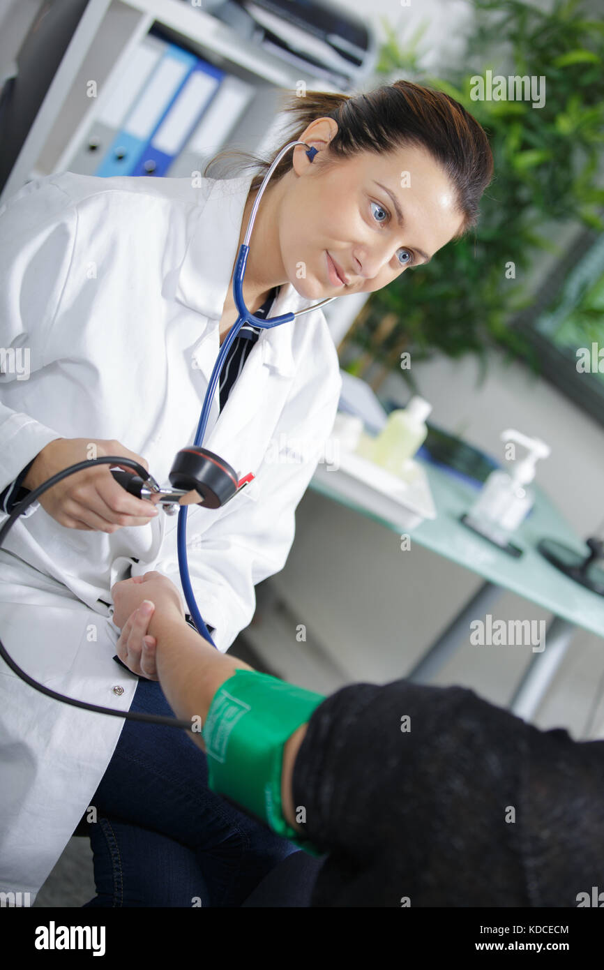 female doctor measuring patients pressure Stock Photo - Alamy