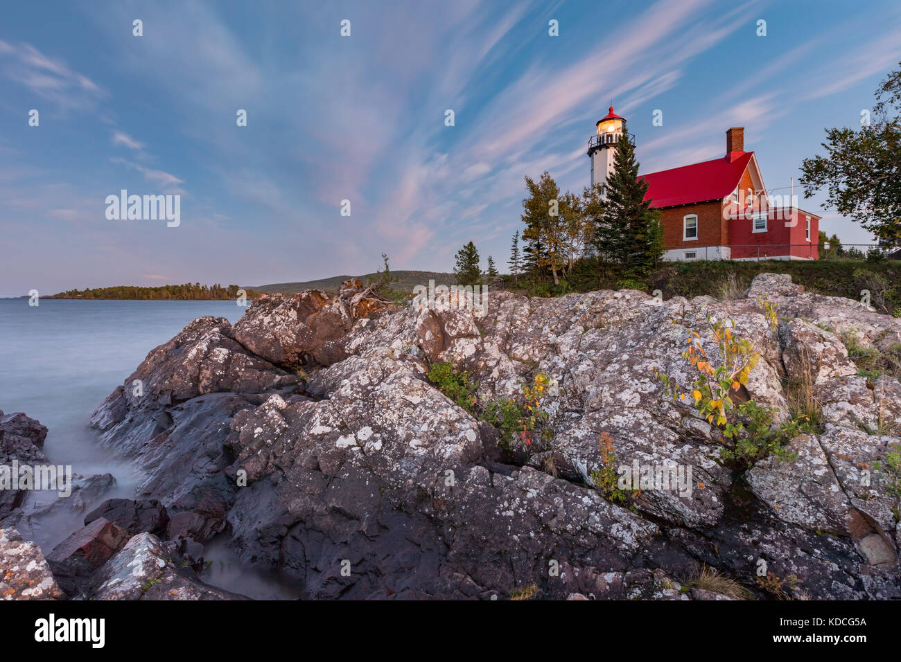 Eagle Harbor Light stands above a rocky entrance to Eagle Harbor in the