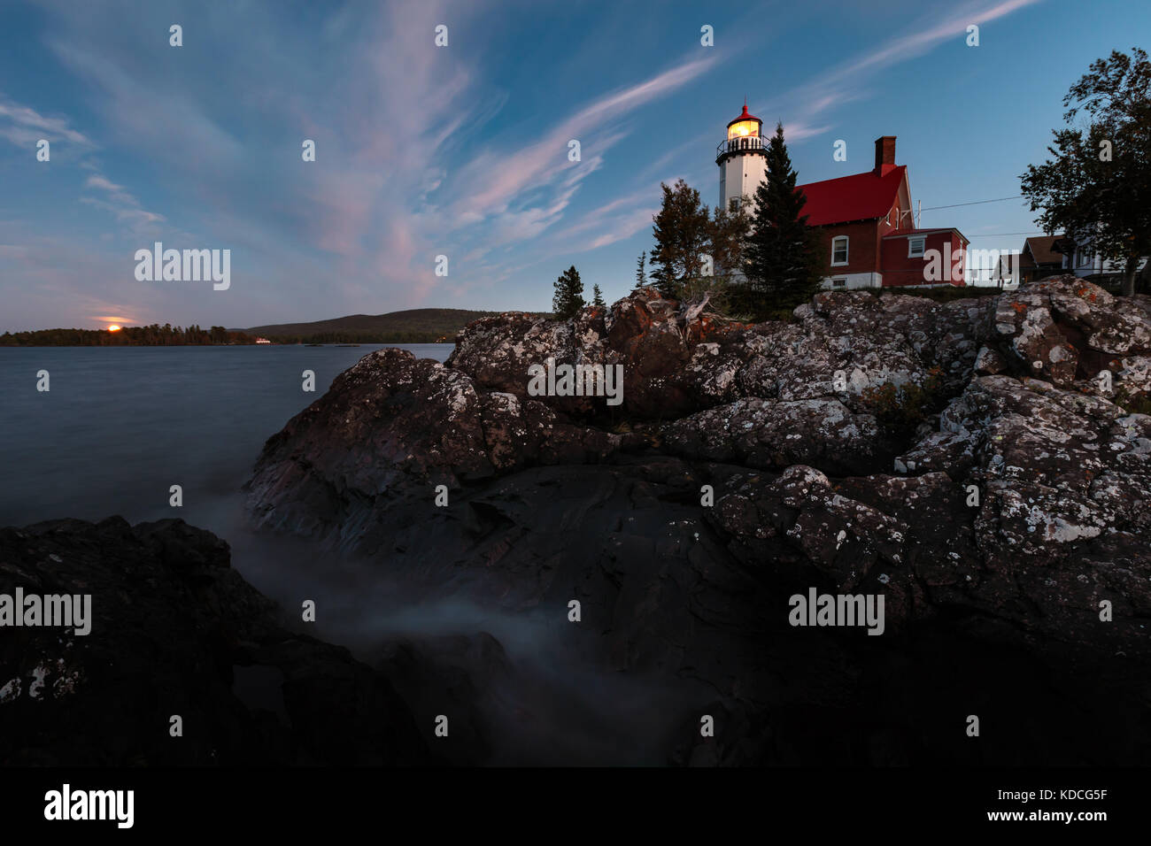 Eagle Harbor Light stands above a rocky entrance to Eagle Harbor in the ...