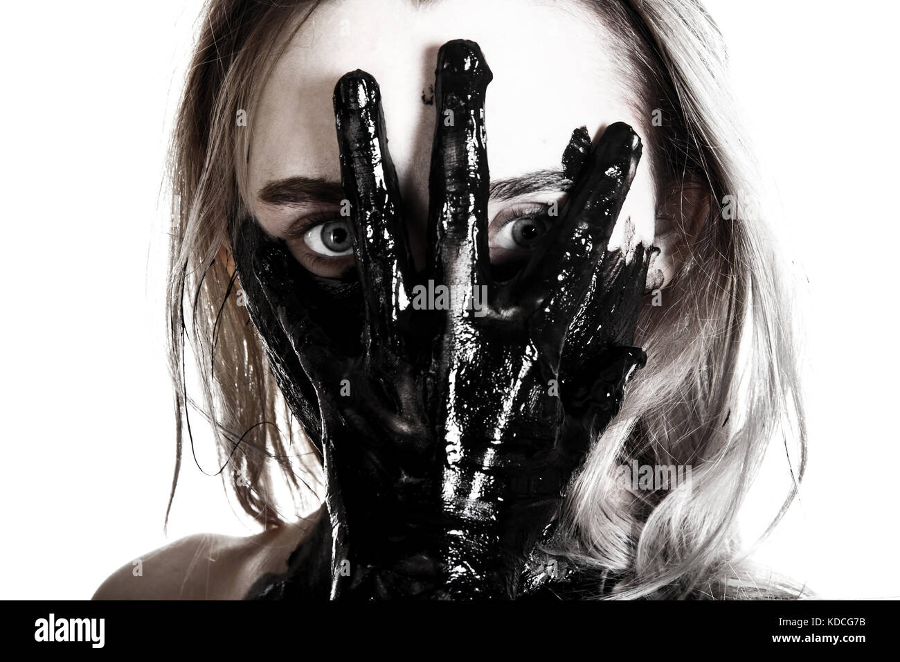 Young woman holding a tarred hand on her face Stock Photo