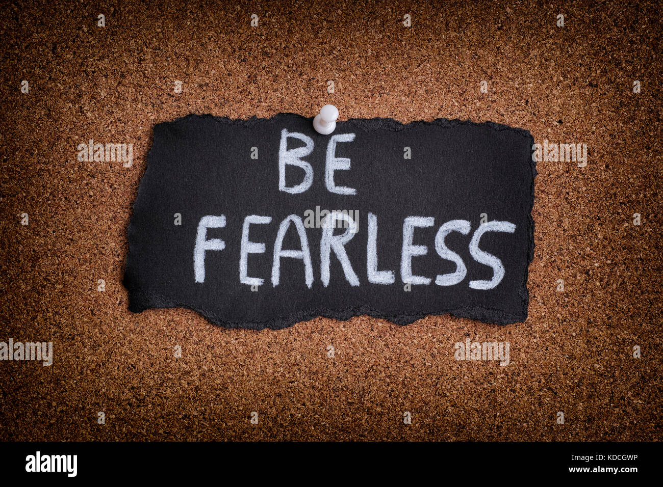 Be Fearless. Piece of black paper with phrase Be Fearless. Close up. Stock Photo