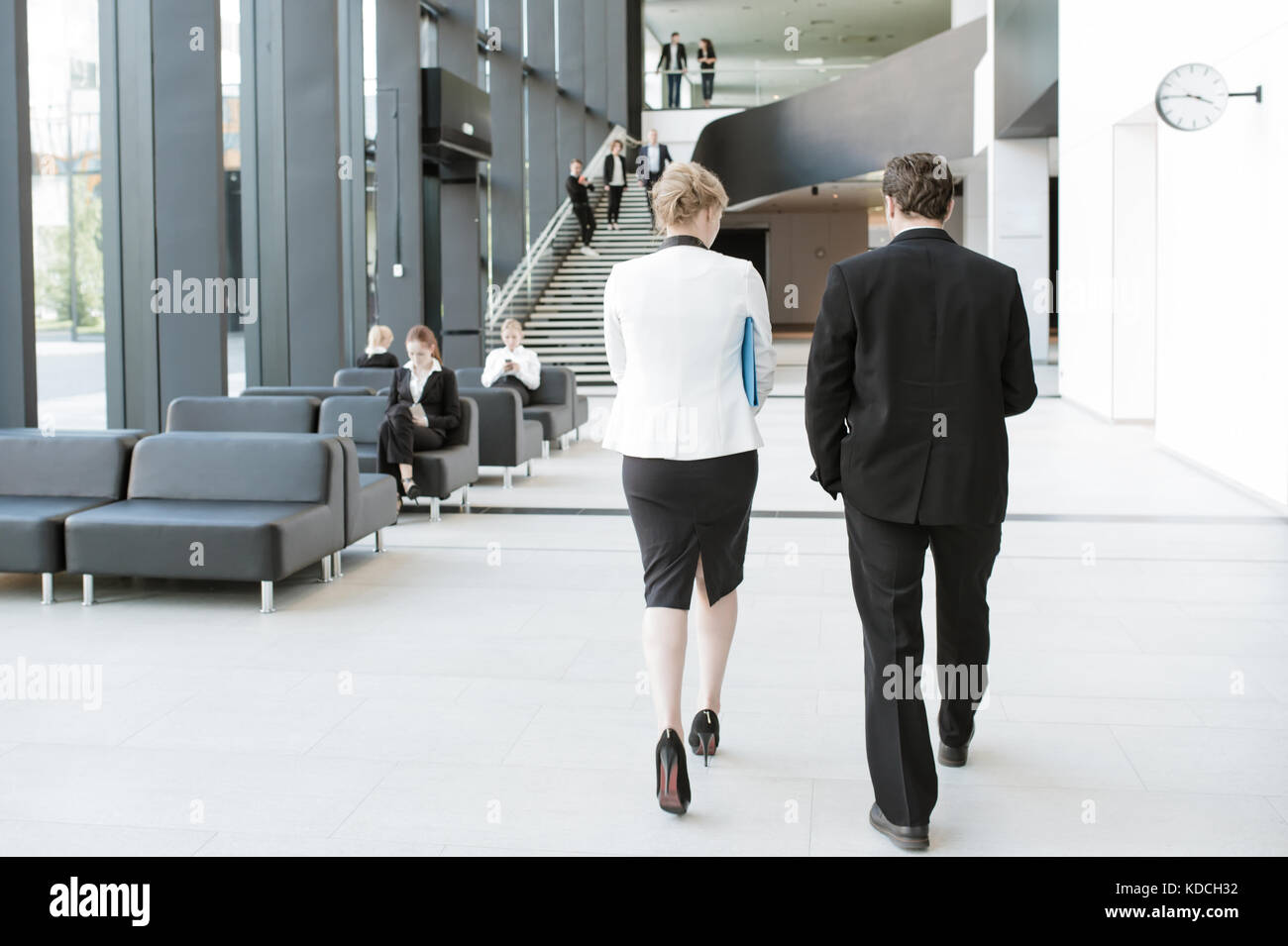 Modern business people walking in glass hall of office building Stock ...