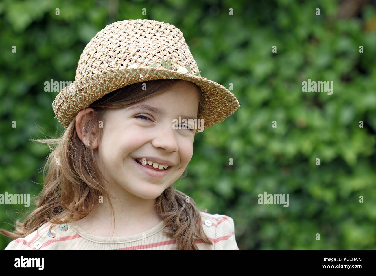happy little girl with straw hat portrait Stock Photo - Alamy