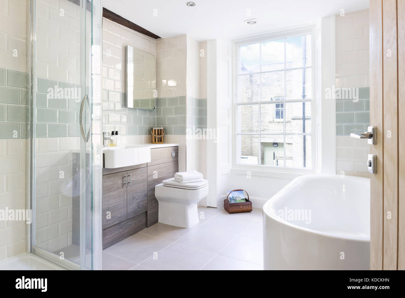 A contemporary, tiled remodelled bathroom in a redeveloped period UK home. Stock Photo