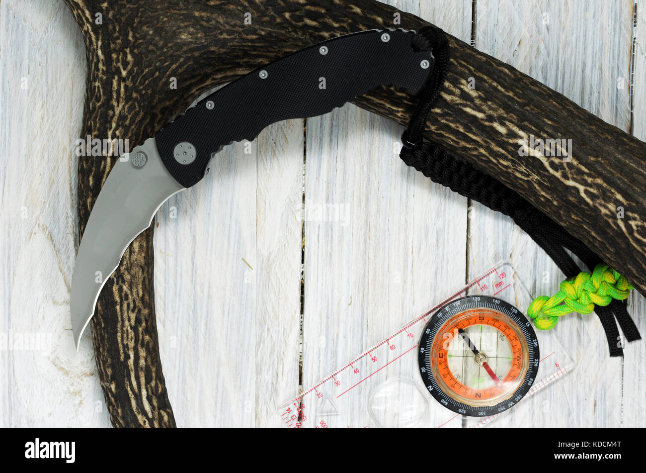 Knife, compass and deer horn on a white background. Tactical