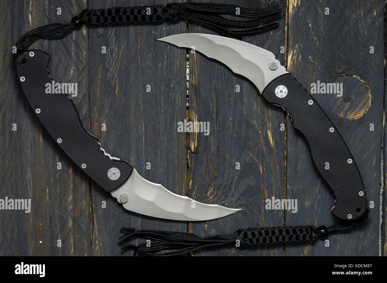 Two military knives on a black background. Two semicircular knives