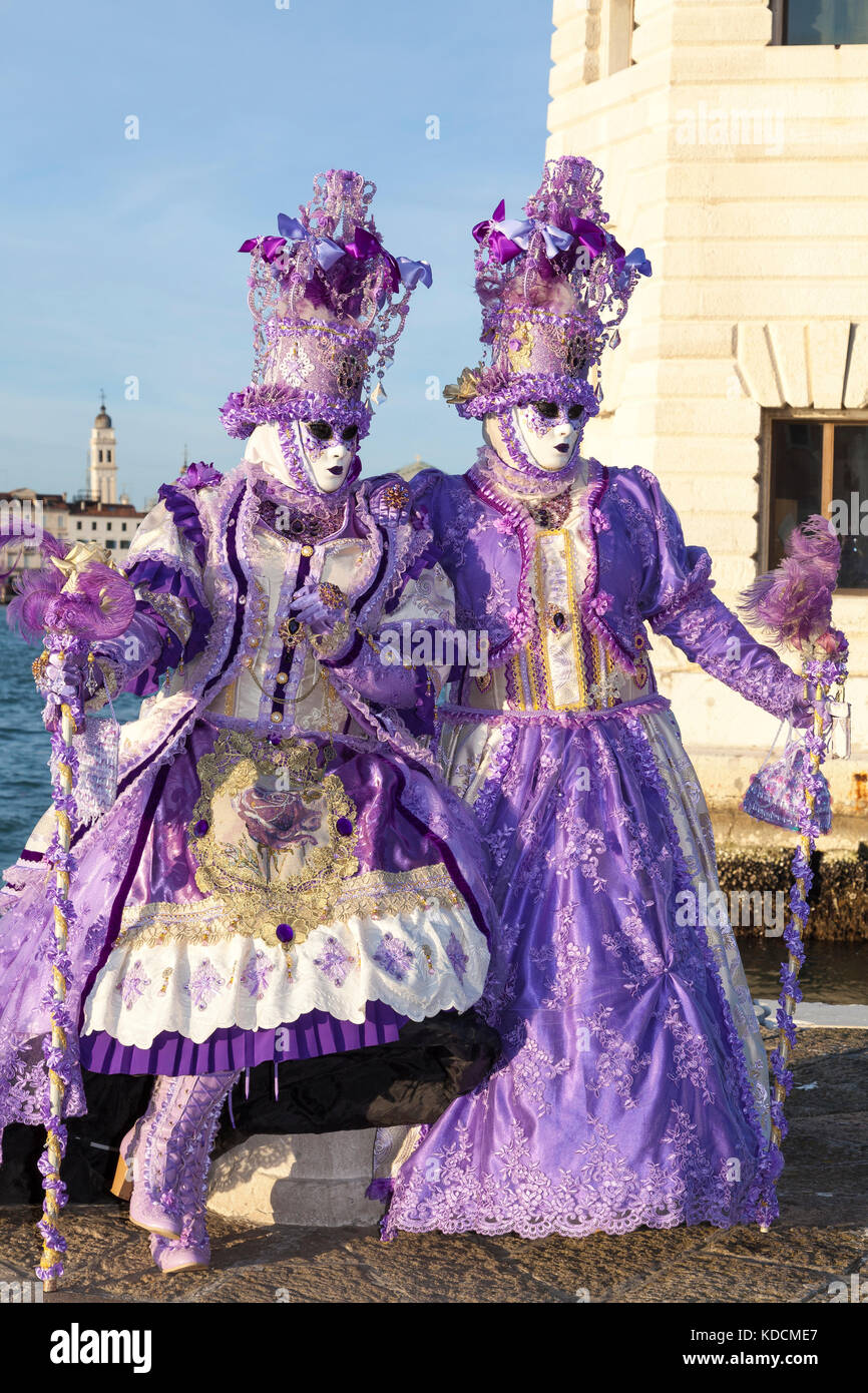 2017 Venice Carnival, Venice, Italy, Two women in classical purple costumes  posing at sunset in front of the San Giorgio Maggiore lighthouse with the  Stock Photo - Alamy