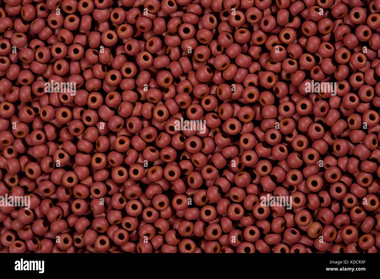 Red seed beads background. Stock Photo