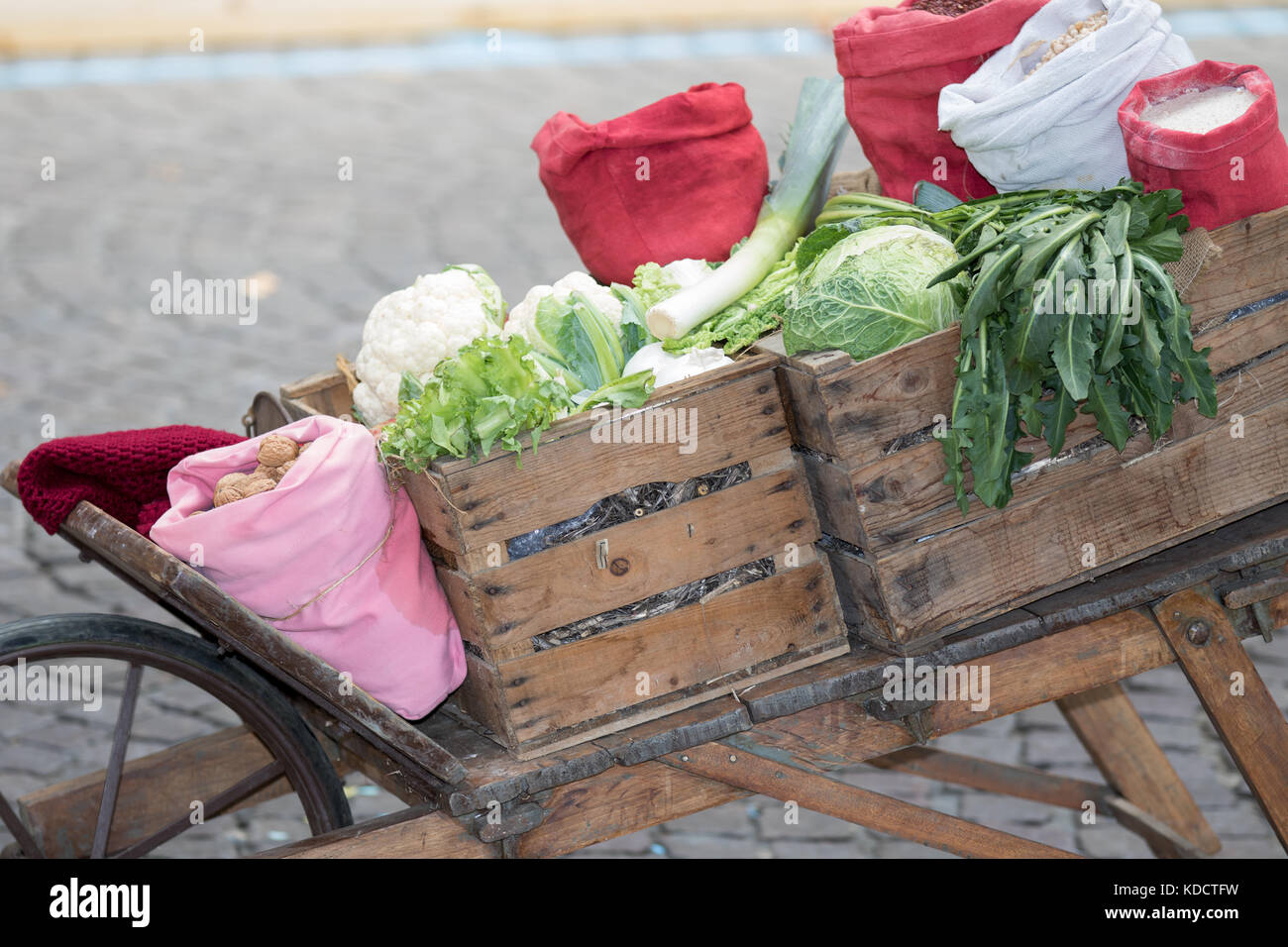 Asti, Italy - September 10, 2017: wooden cassettes full of cauliflowers on an old wooden wheelbarrow Stock Photo