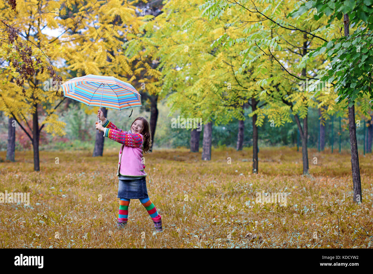 happy little girl in autumn park Stock Photo - Alamy