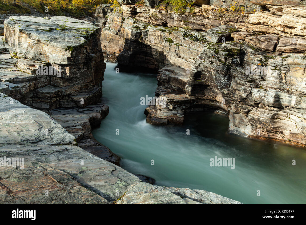 Soft rapids in a river, surrounded of cliffs, rocks. Some sunshine ...