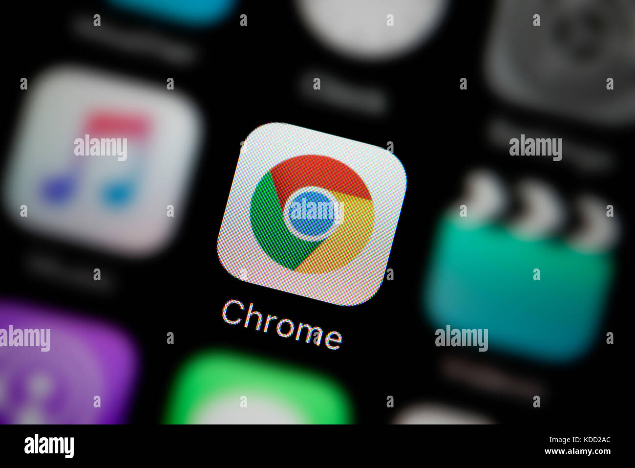 A close-up shot of the logo representing Google Chrome app icon, as seen on the screen of a smart phone (Editorial use only) Stock Photo