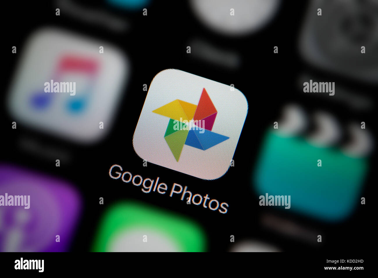 A close-up shot of the logo representing Google Photos app icon, as seen on the screen of a smart phone (Editorial use only) Stock Photo