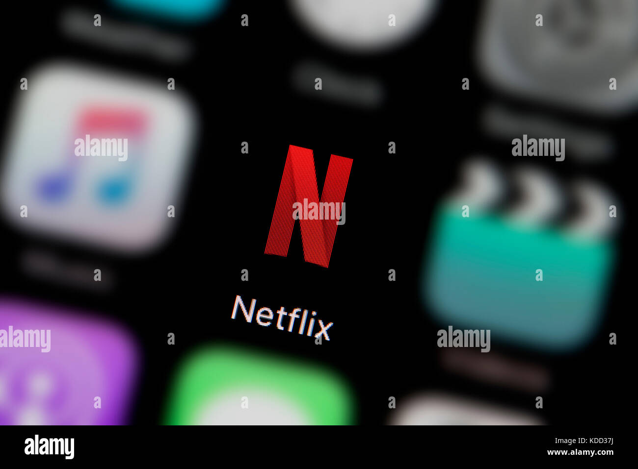 A close-up shot of the logo representing Netflix app icon, as seen on the screen of a smart phone (Editorial use only) Stock Photo