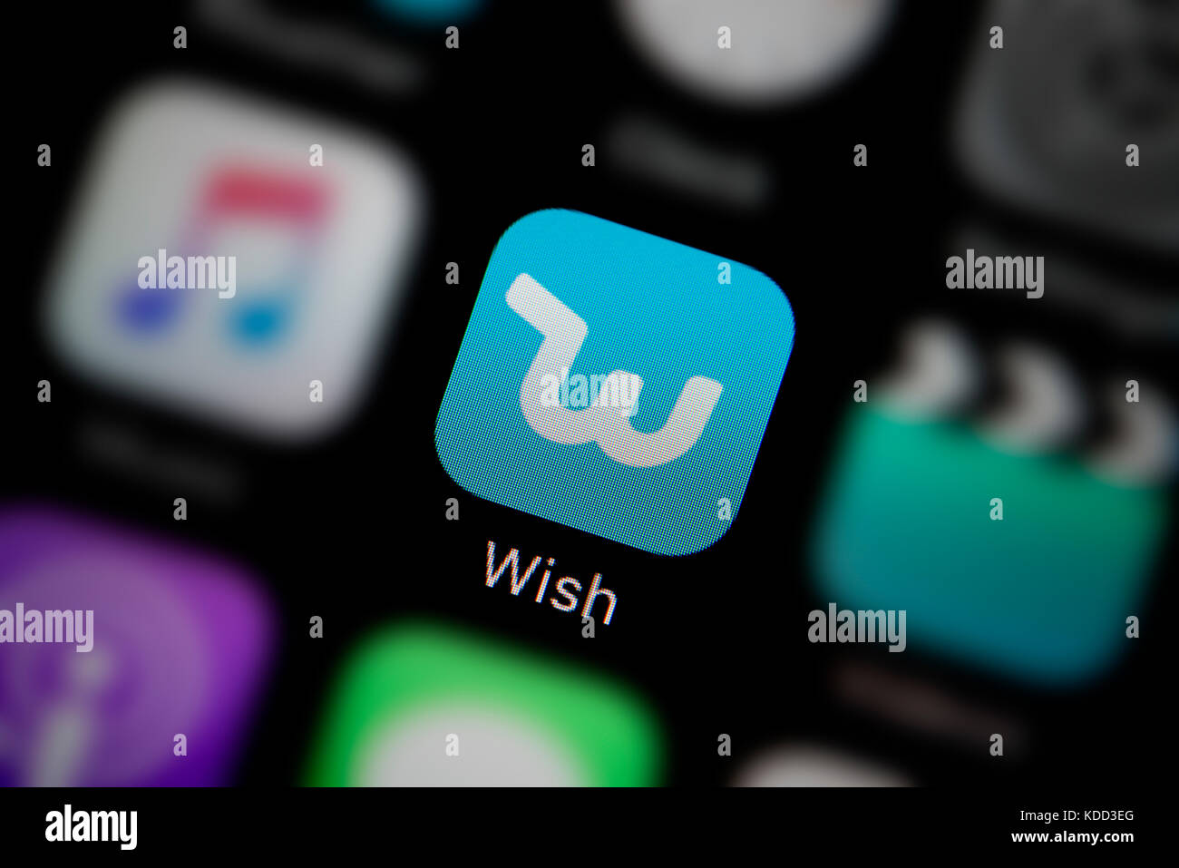 A close-up shot of the logo representing the Wish app icon, as seen on the screen of a smart phone (Editorial use only) Stock Photo